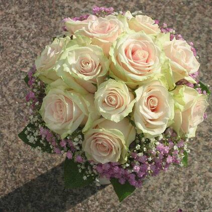 Runder Brautstrauß aus cremefarbenen Rosen mit zartrosa Blüten